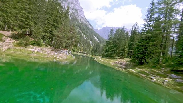 Gr&uuml;ner See Styria, Trag&ouml;ss, Austria FPV drone arial with mountain view and green water