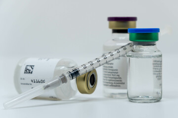 bottles with medication and injection solution, syringe, equipment for vaccination