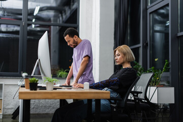 focused multiethnic colleagues working on start up in modern office.