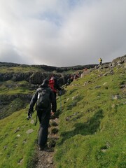 A group of hikers in the hills and mountains of the Faroe Islands