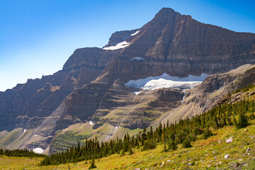 Matahpi Peak and valley below viewed from Siyeh Pass hiking trail, Glacier National Park, Montana....