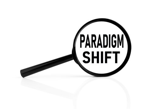 paradigm shift. text inside the magnifier. magnifying glass on white background