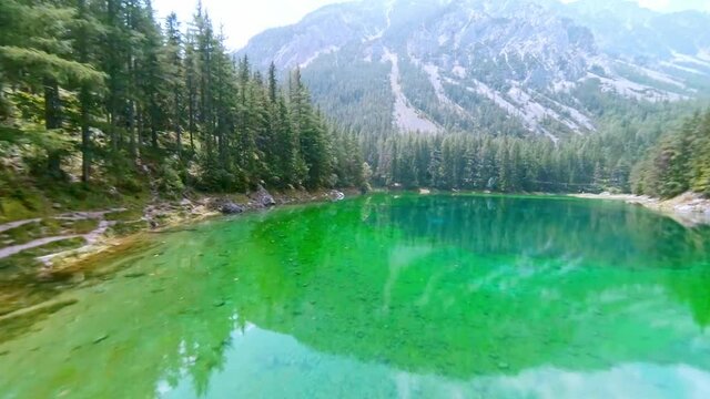 Gr&uuml;ner See Styria, Trag&ouml;ss, Austria FPV drone arial with mountain view and green water