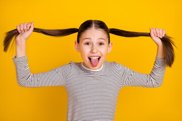 Photo of young attractive girl happy positive smile fooling grimace tongue-out isolated over yellow color background - obrazy, fototapety, plakaty