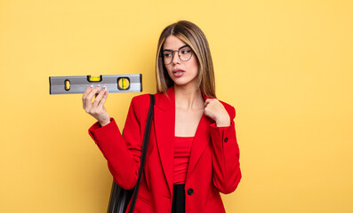 architect woman feeling stressed, anxious, tired and frustrated and holding a level balance