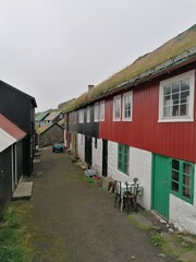 The cute and cozy old historical houses of the Faroe Islands with grass on the roof