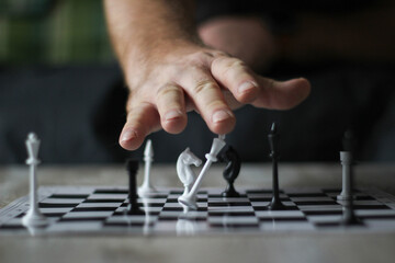 hand rearranging chess on the chessboard