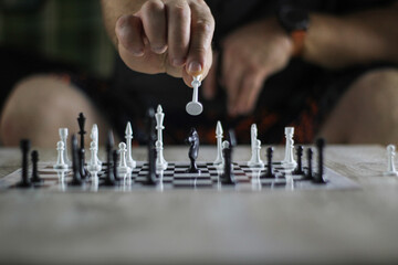 hand rearranging chess on the chessboard