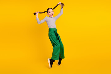 Full body profile side photo of young excited girl happy positive smile fooling isolated over yellow color background