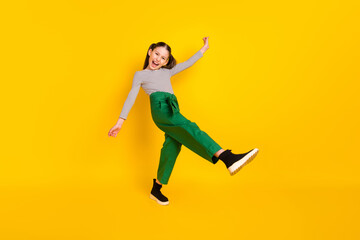 Fototapeta na wymiar Full size profile side photo of young excited girl happy positive smile have fun isolated over yellow color background
