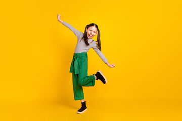 Fototapeta na wymiar Full body profile side photo of young school girl happy positive smile have fun isolated over yellow color background