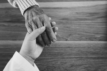 The doctor shook the patient's hand as a sign of encouragement.