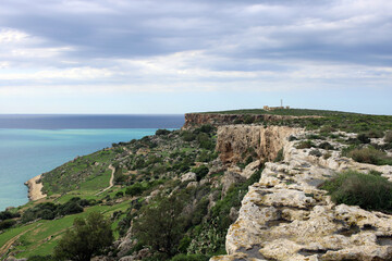Fototapeta na wymiar Rocky shore of Malta island, Mellieha, with steep cliffs