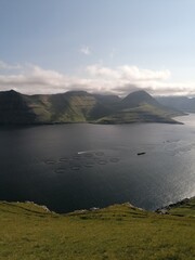 Stunning mountain views in the green and lush hills of the Faroe Islands in the Atlantic Sea