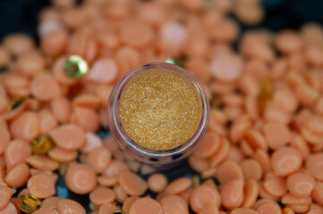 Eyeshadow in a jar top view on a blurred background. 