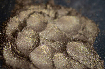 Cosmetics . Brown gold shiny glitter. Pile on the table