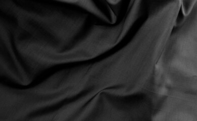 Fototapeta premium Dark moody twisted fabric with shallow depth of field for texture background