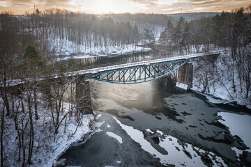 Winter scenery of the railway bridge in Rutki over Radunia river, Kashubia. Poland
