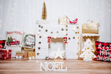 beautiful christmas decoration at home. Chimney, gifts, tree, noel, cushions on beautiful indoor...