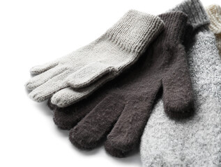 Warm gloves and mittens on white background, closeup