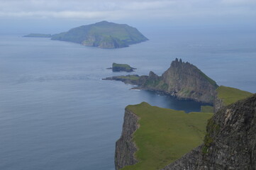 The green and blue dramatic and wild coastal landscapes in the Faroe Islands