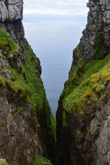 The green and blue dramatic and wild coastal landscapes in the Faroe Islands