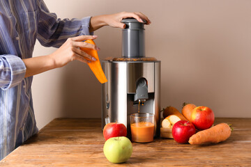 Woman making fresh juice on table