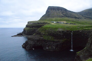 The green and blue dramatic and wild coastal landscapes in the Faroe Islands