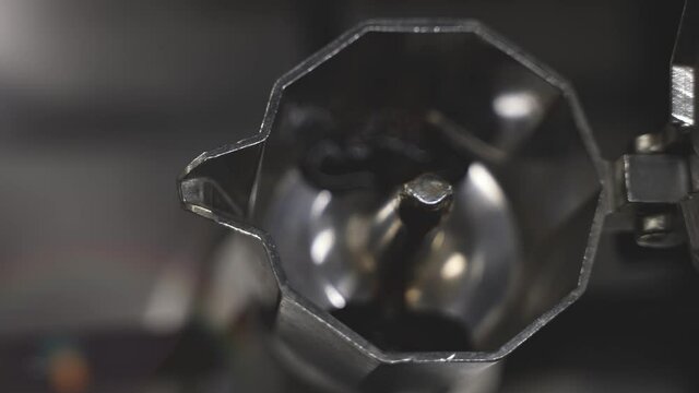 Top view shot of an Italian moka traditional coffee machine with fresh hot strong coffee under the morning sunlight.