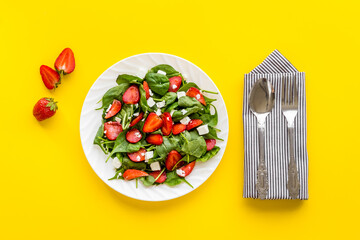 Vegan meal - spinach salad with strawberry and goat cheese