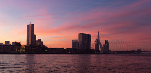 Purple pink blue Morning view of the Skyline of Rotterdam and the Erasmus Bridge, seen from the Maas (Meuse), the Netherlands.