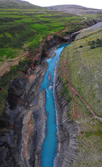 Fototapeta na wymiar basalt canyon with a blue glacial river, famous studlagil in the eastern highlands