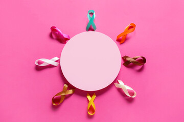 Composition with blank card and awareness ribbons on pink background. World Cancer Day