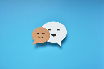 Conversational clouds with smiles. A symbol of positive conversations