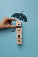 The silhouette of an umbrella and the icons of a cross, a house, a person and an airplane. Accident...
