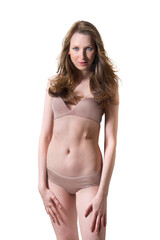 Fototapeta premium Closeup portrait of a slim young woman wearing a beige bikini, isolated in front of white studio background
