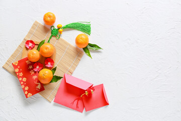 Red envelopes with Chinese tangerines on white background. New Year celebration