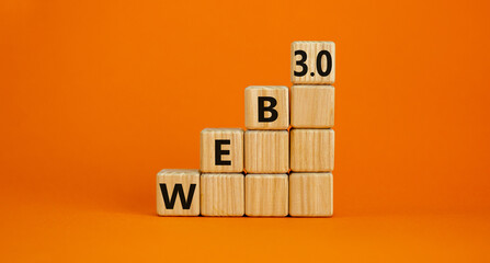 WEB 3.0 symbol. Wooden cubes with concept words WEB 3.0. Beautiful orange table, orange background, copy space. Business, technology web3 and WEB 3.0 concept.