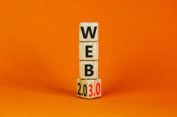 WEB 2.0 or 3.0 symbol. Turned a wooden cube and changed words WEB 2.0 to WEB 3.0. Beautiful orange table, orange background, copy space. Business, technology and WEB 2.0 or 3.0 concept.