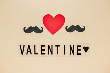 Word VALENTINE with paper mustaches and heart on light background. LGBT concept
