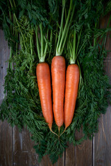 Carrots bunch on rustic background. Vegetarian and vegan food.