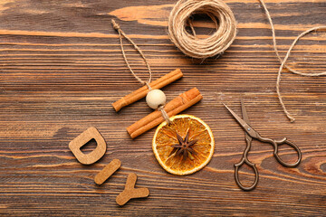 Word DIY, handmade Christmas toys and scissors on wooden background
