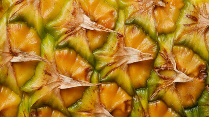 Yellow an green pineapple skin texture. Close up of pineapple texture background