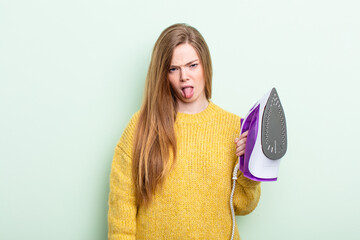 redhair woman feeling disgusted and irritated and tongue out. iron clothes concept