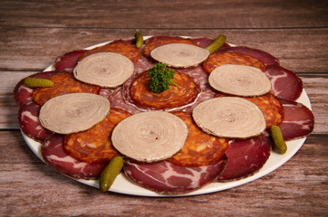 Food tray with delicious salami, pieces of sliced ham, sausage, Deli meats, Pickles, Hight quality photo