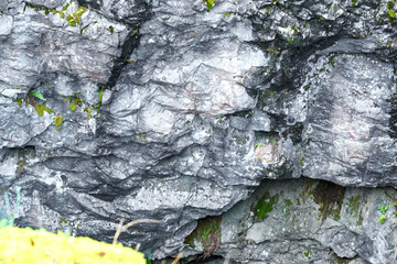 A wall of an abandoned marble quarry covered with moss. Ruskeala Mountain Park, Karelia
