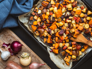 Roasted root vegetables on a baking sheet. - Powered by Adobe
