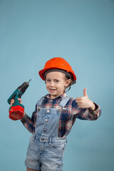 Happy caucasian girl in orange safety helmet,holding screwdriver at hands