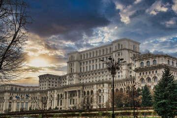 Fototapeta na wymiar Palace Of The Parliament With A Dramatic Sky, Located In The Center Of Bucharest, Romania. Travels And Tourism. Famous Architecture And Buildings. Eastern Europe