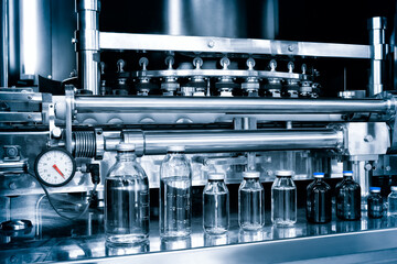pharmaceutical industry, medicine pills are filling in the  glass bottle on production line machine...